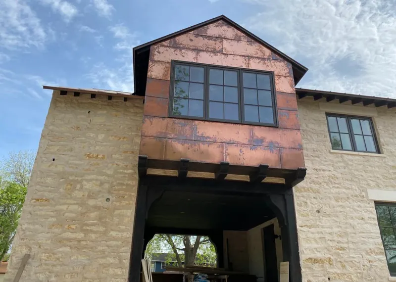 Copper metal panel facade on a stone building for Roof Repair in Blue Springs