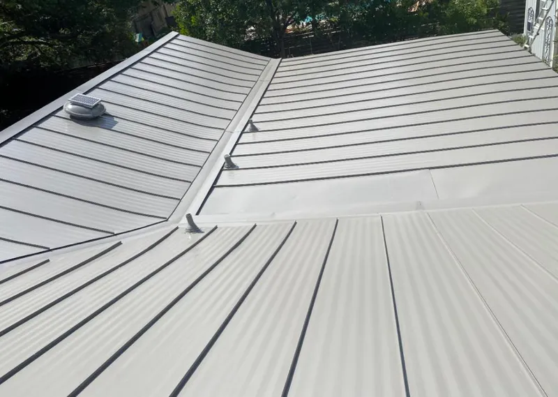 Solar attic fan installed on a metal roof for Roof Ventilation in Blue Springs